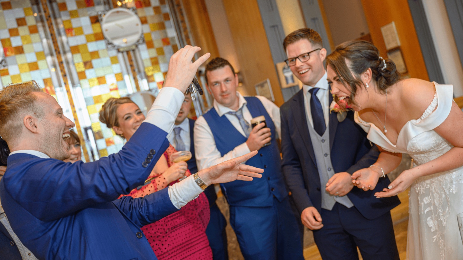 Wedding party gathered around a card trick in Wexford