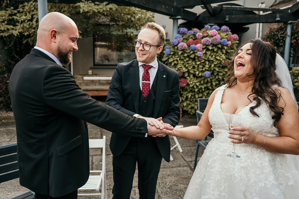 Black-and-white portrait of Kristian with a bride and groom